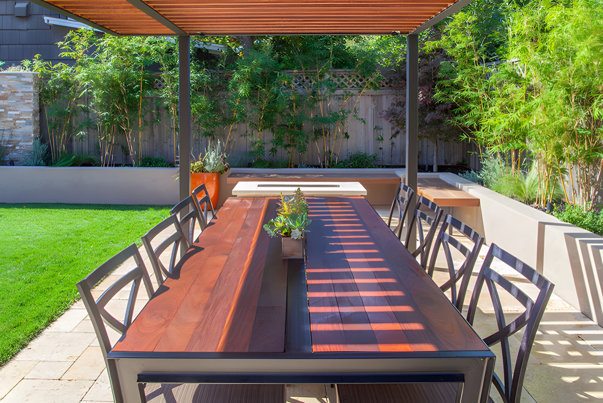 Outdoor dining terrace with pergola and planting